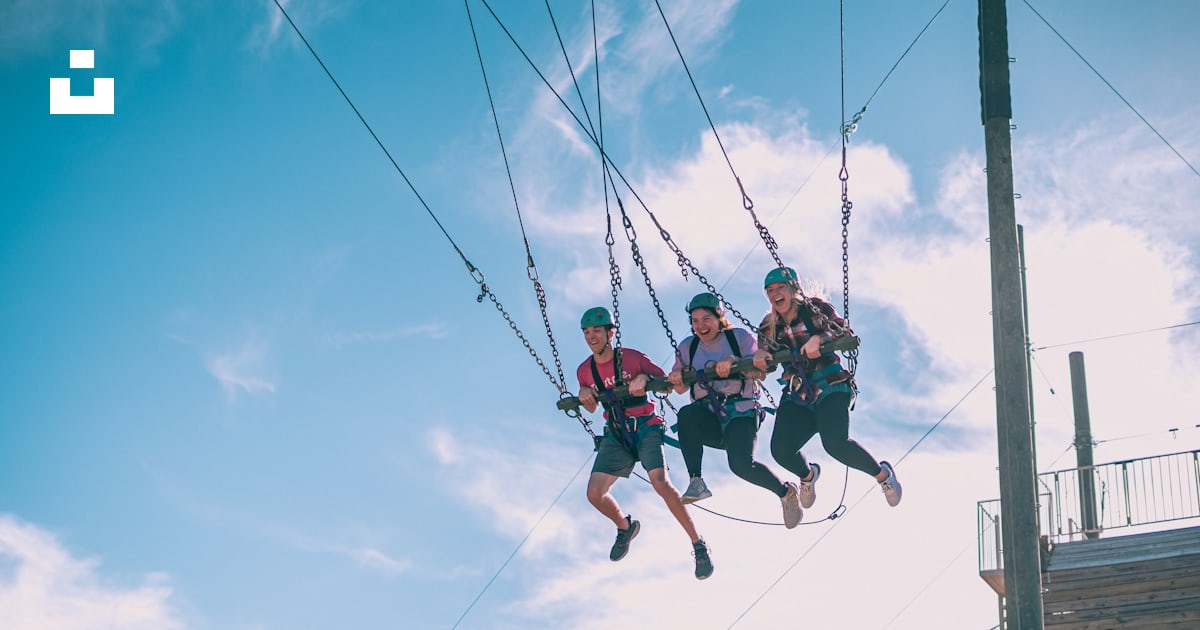 A group of people riding zip lines in the air photo – Free Capitan ...