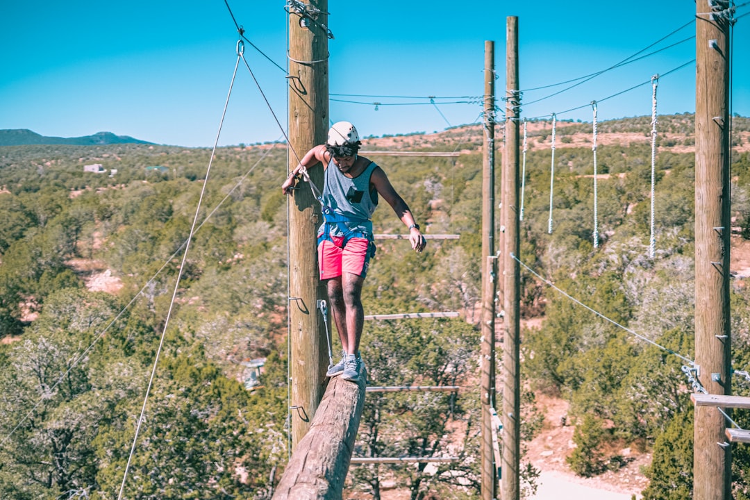 young adult completing ropes course challenge