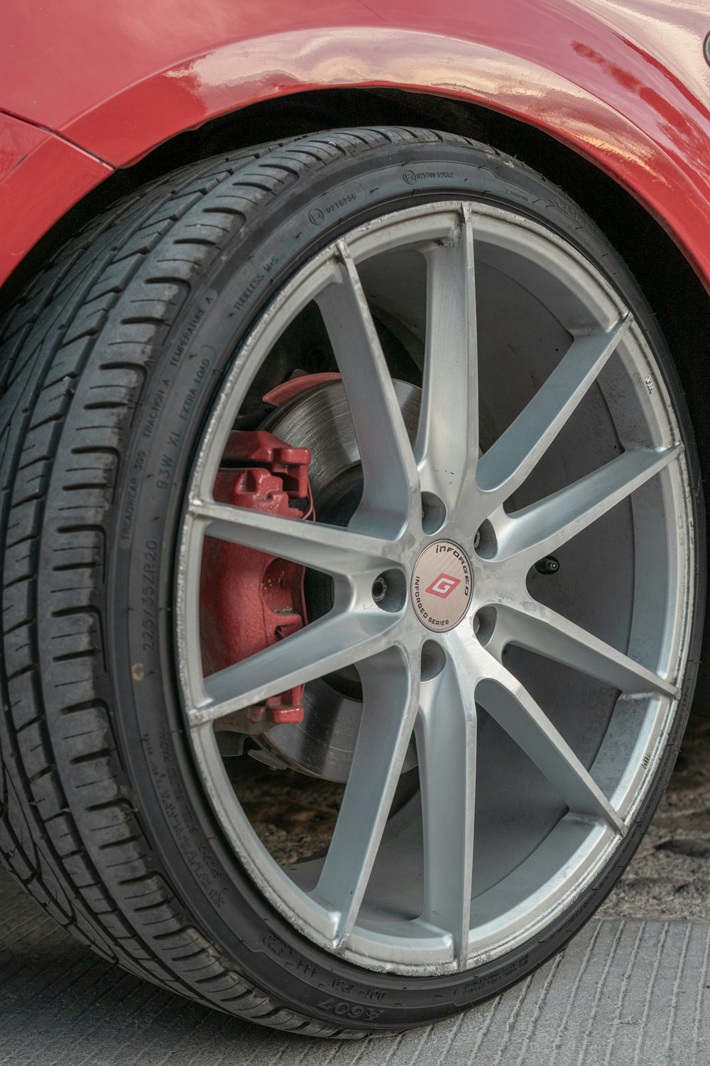 a close up of a red sports car tire