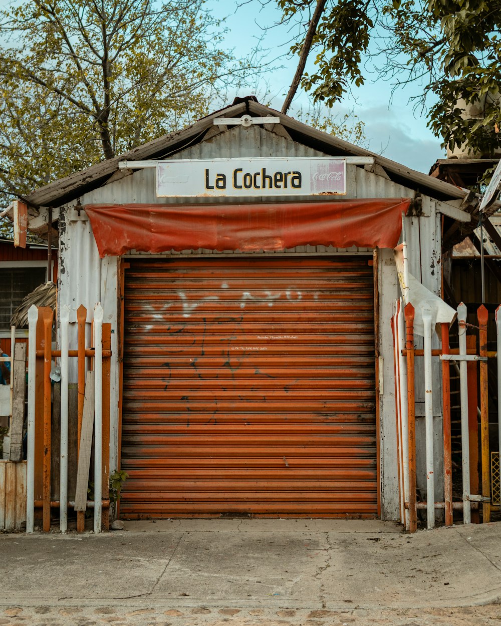 a closed garage with a red awning