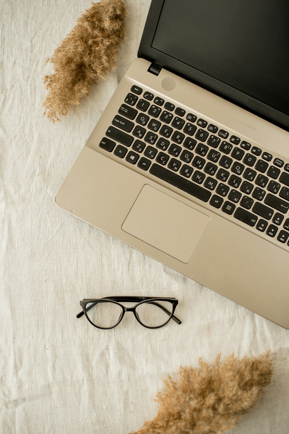 a laptop computer sitting on top of a white table