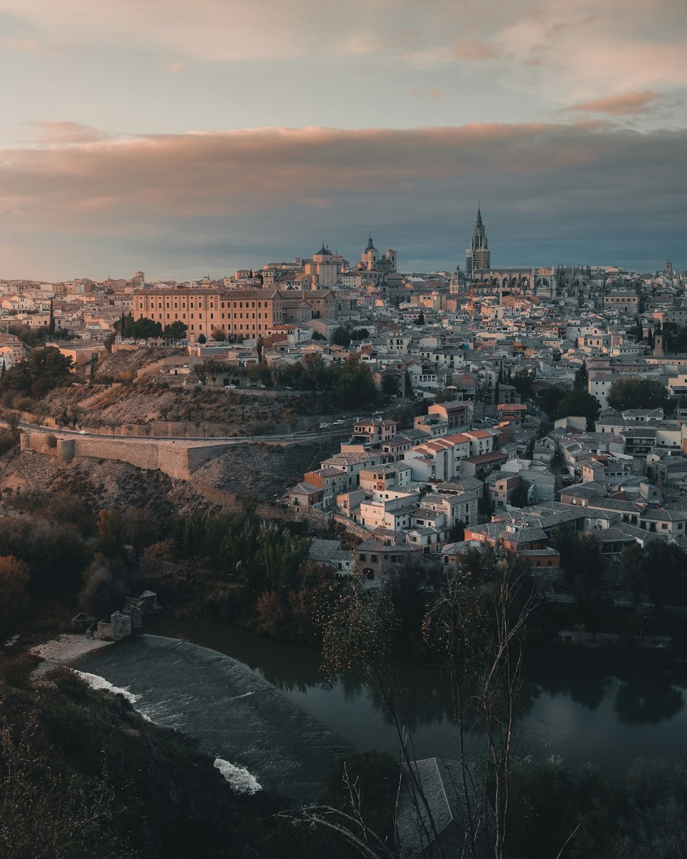 a view of a city with a river in the foreground