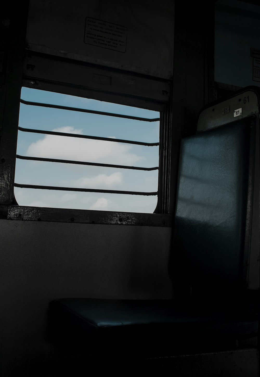 a window in a train car with a sky view