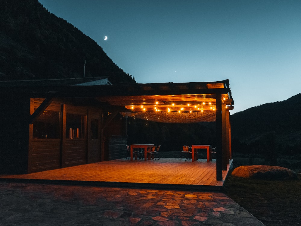 a wooden deck with lights hanging from it