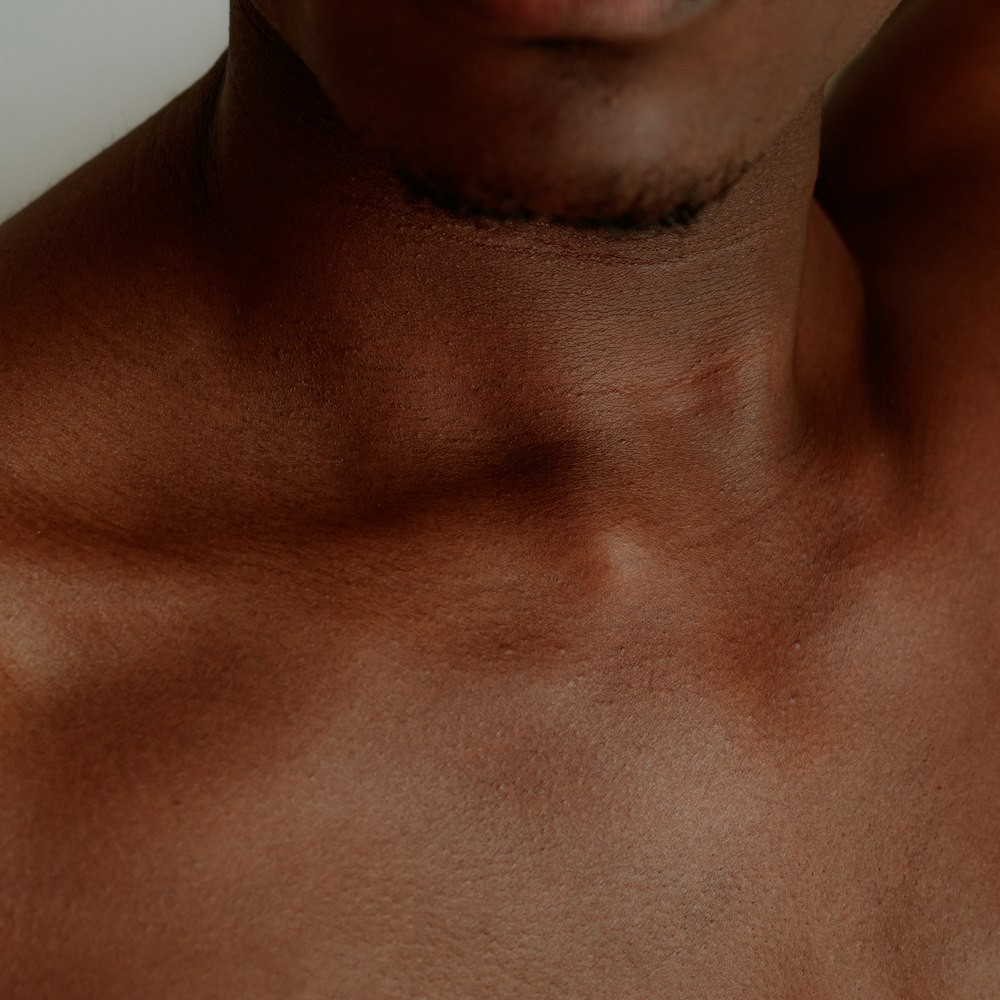 a close up of a man with no shirt on