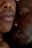 Close-up view of two people resting intimately with their faces closely nestled together. The soft lighting accentuates the texture and warmth of their skin, conveying a sense of comfort and closeness.