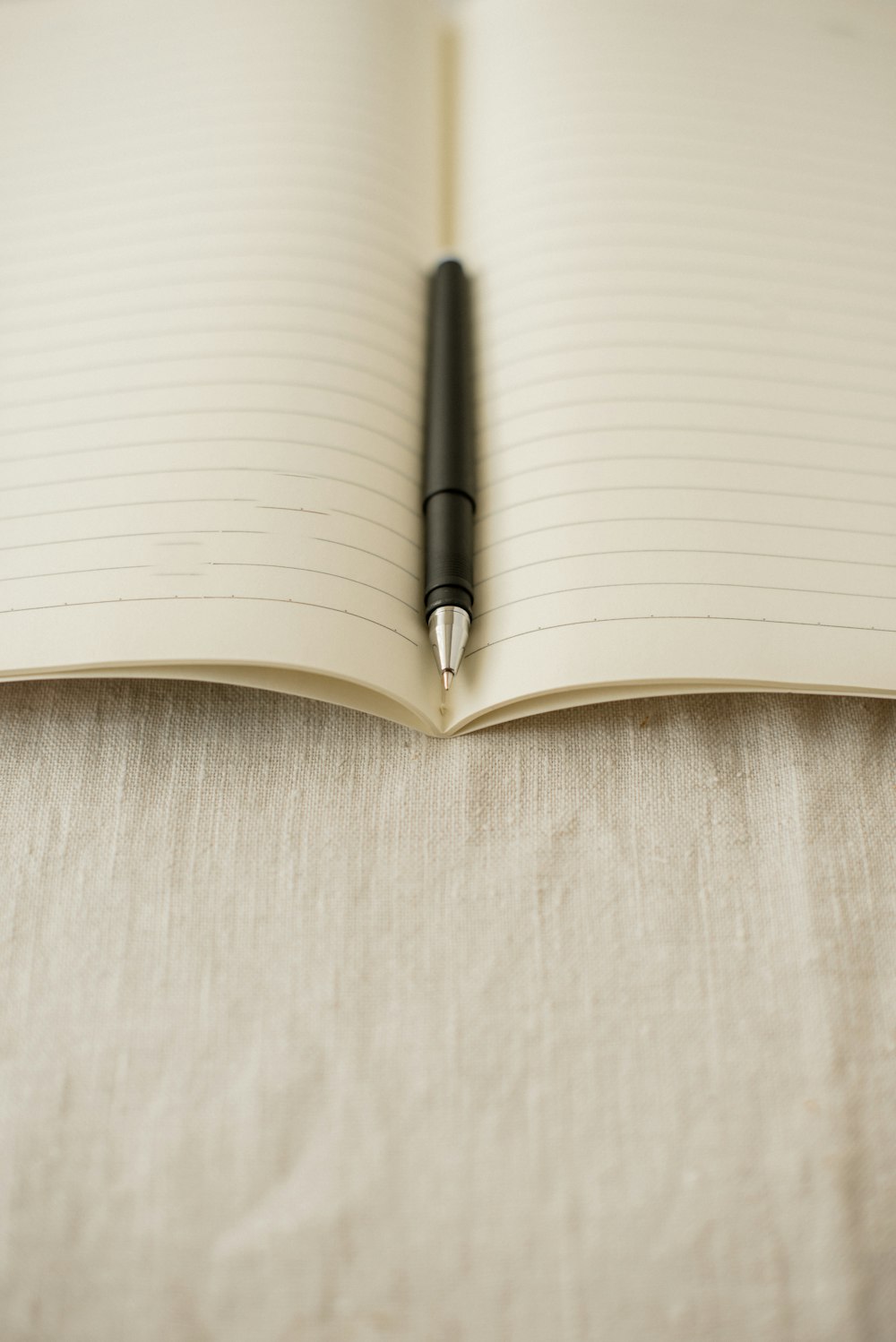 an open notebook with a pen on top of it