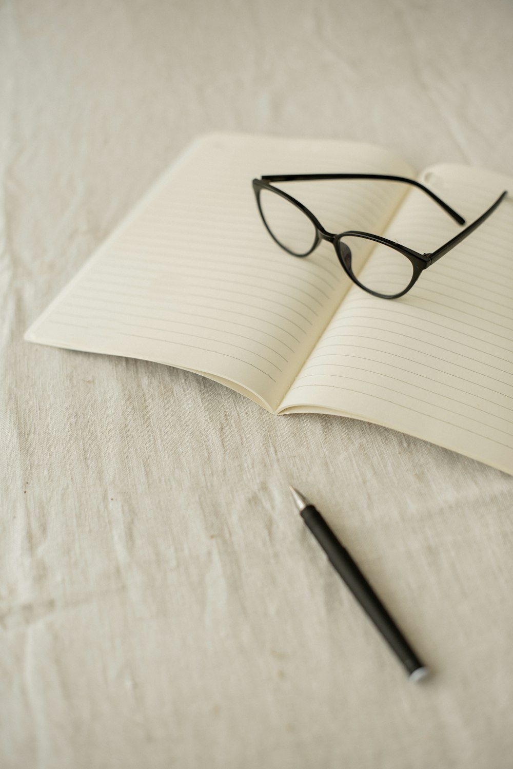 a notebook with a pair of glasses on top of it