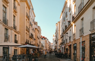 a narrow city street lined with tall buildings
