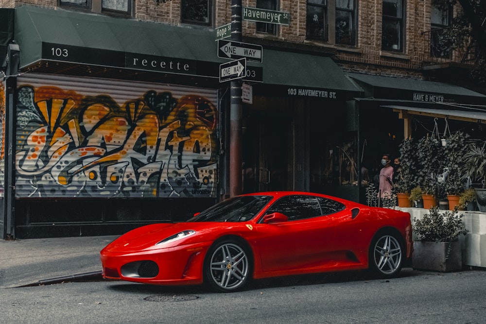 a red sports car parked on the side of the road