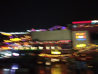 A dazzling aerial nighttime shot of a neon-lit digital strip, glowing with dynamic energy and pulsing club lights.