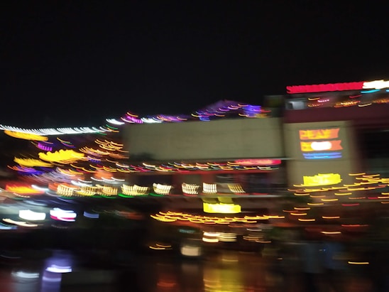 A dazzling aerial nighttime shot of a neon-lit digital strip, glowing with dynamic energy and pulsing club lights.