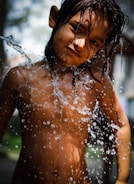 Close-up of a child's hands splashing water joyfully