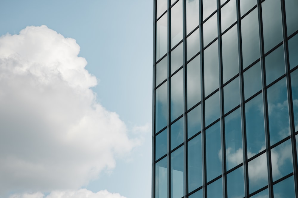 a very tall building next to a very cloudy sky