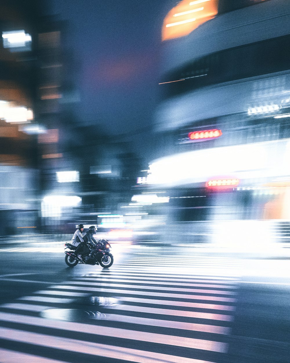 a blurry photo of a person riding a motorcycle