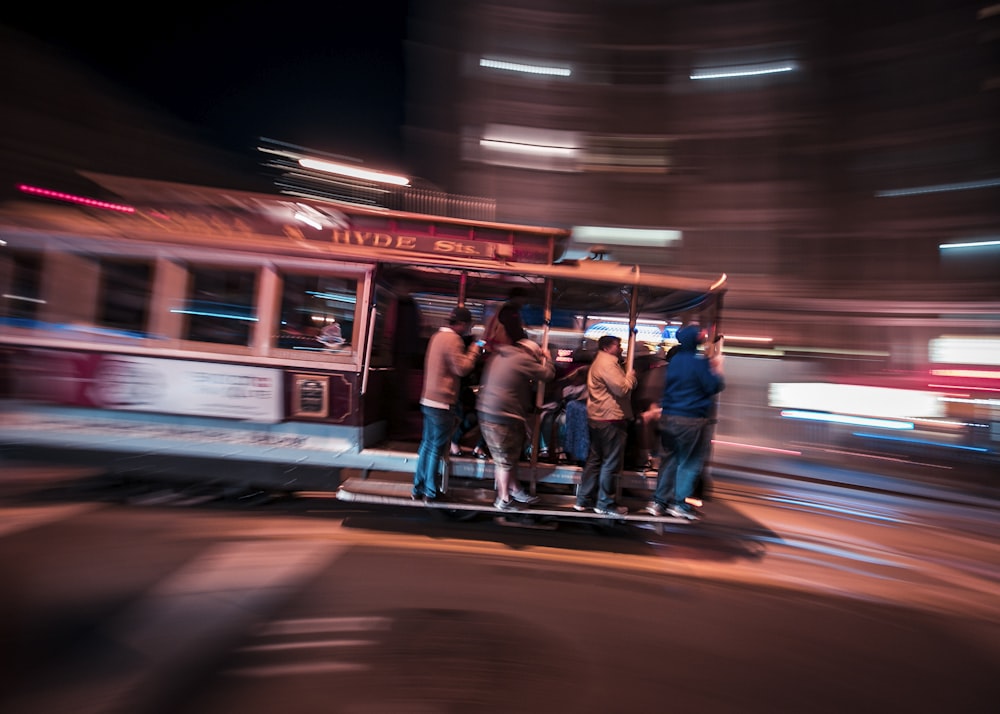 a group of people standing on top of a trolley