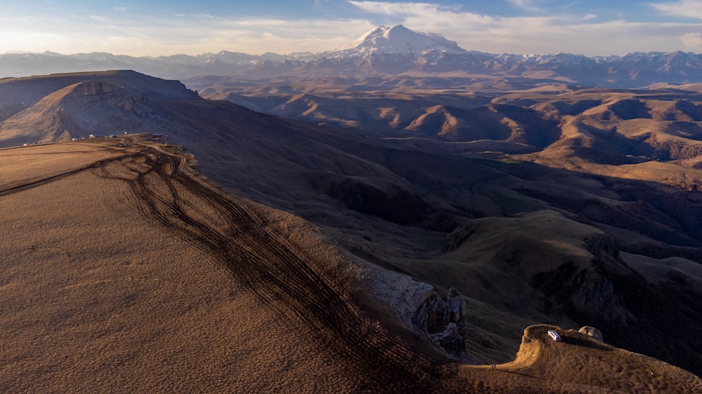 an aerial view of a mountain range with mountains in the background