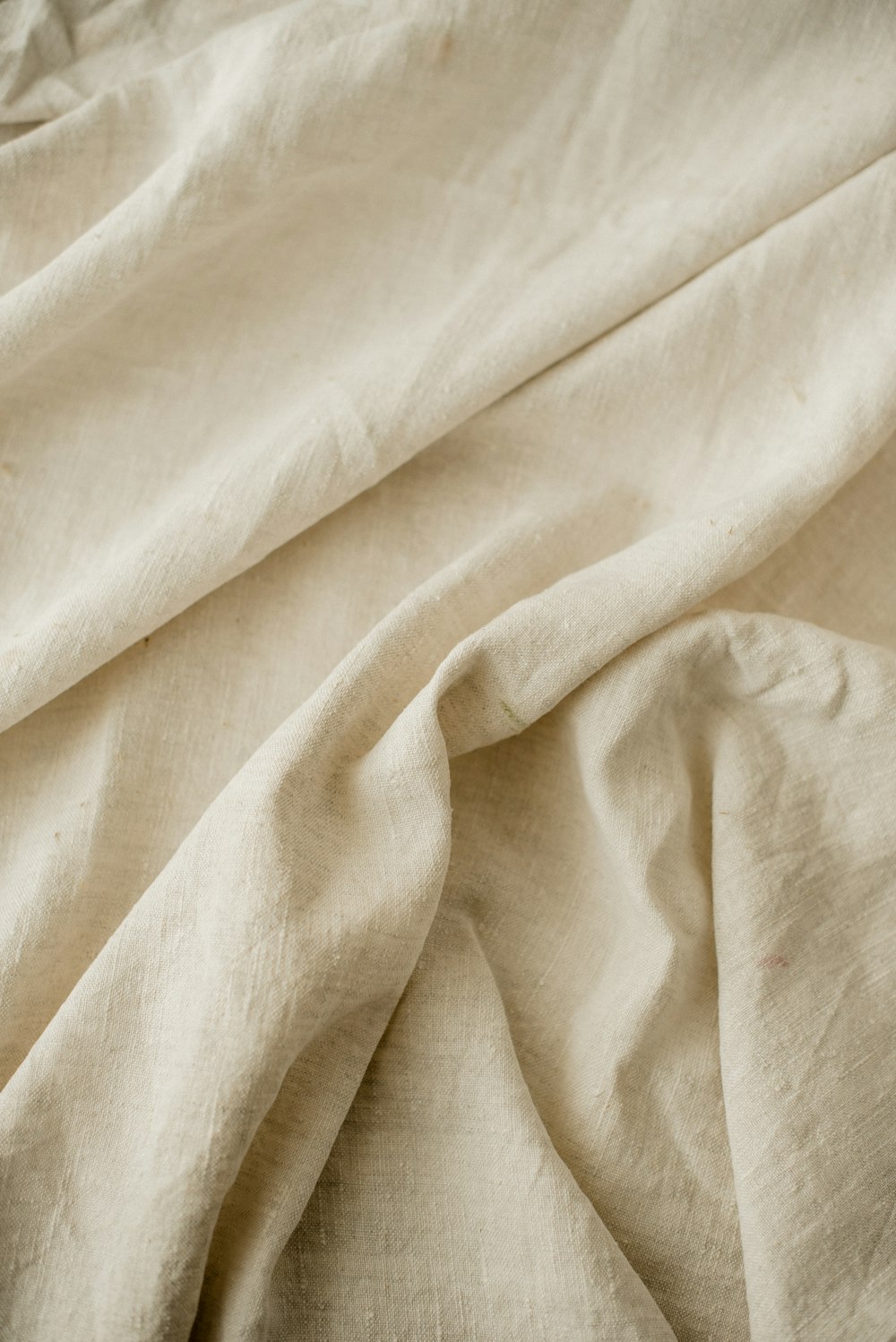 a close up of a bed with a white sheet