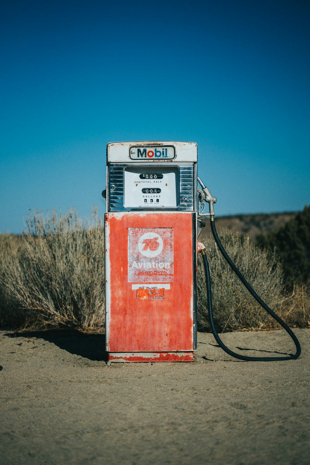 an old gas pump in the middle of nowhere