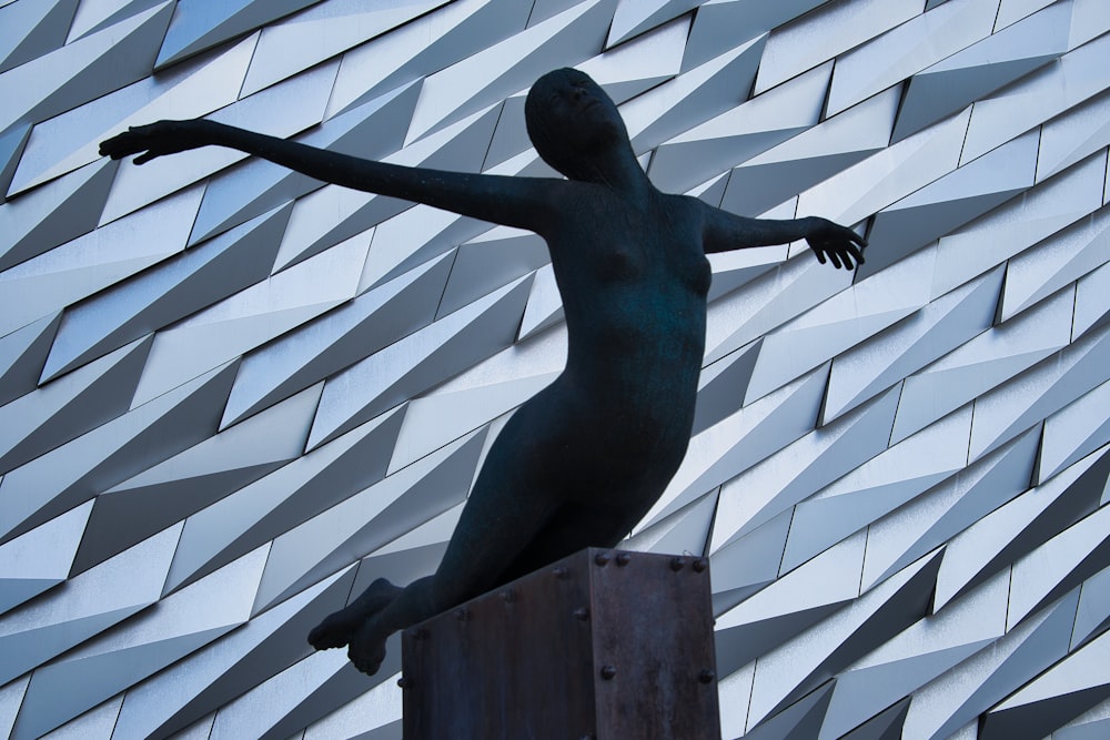 a statue of a woman standing on top of a box