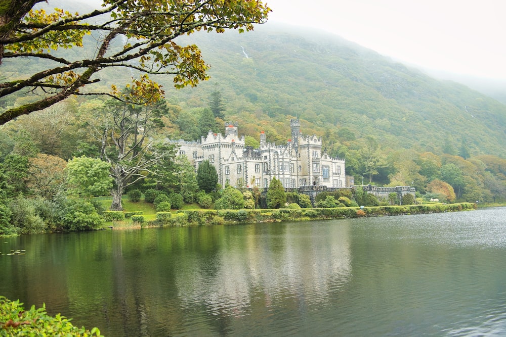 a large castle sitting on top of a lush green hillside