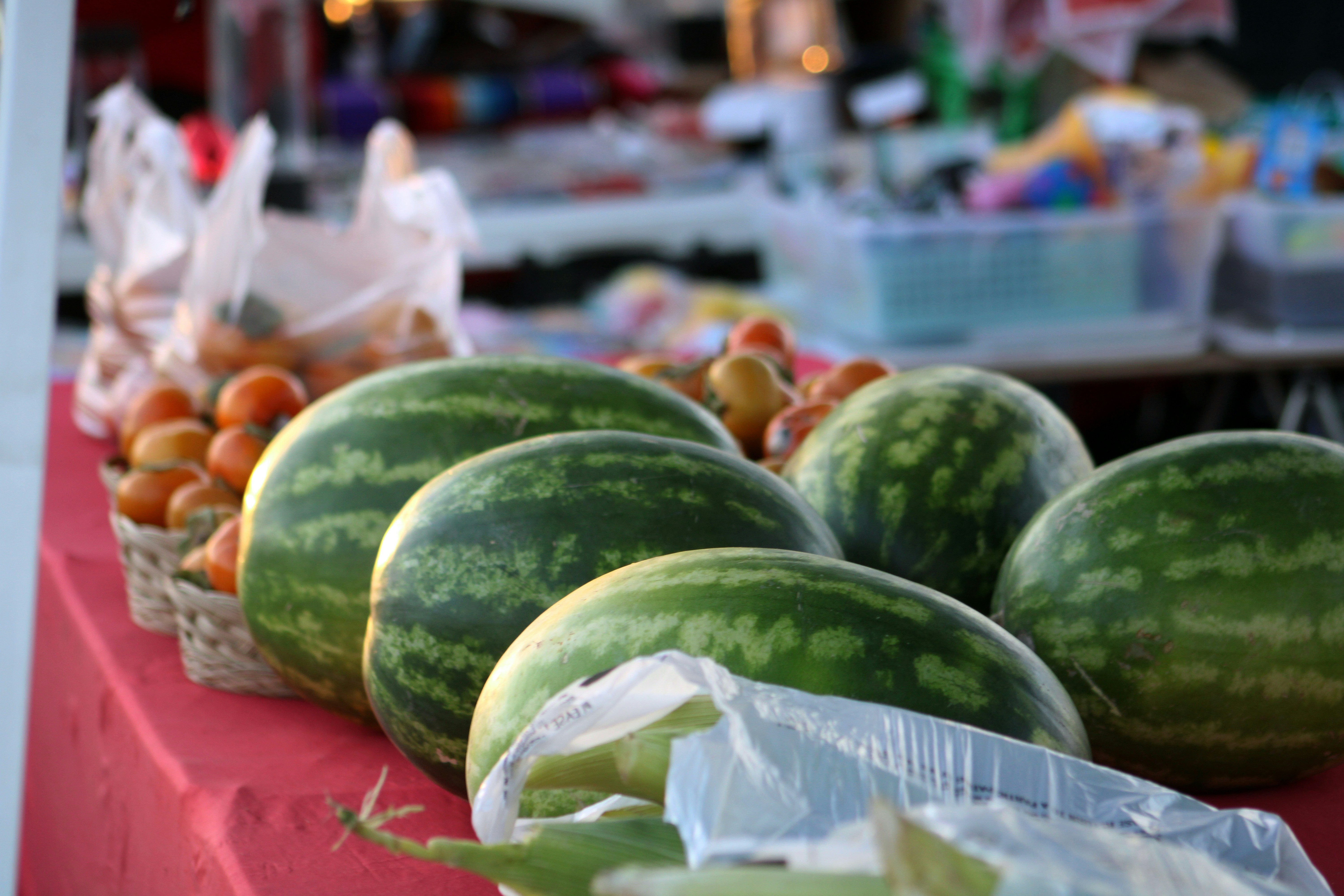 a bunch of watermelons sitting on table