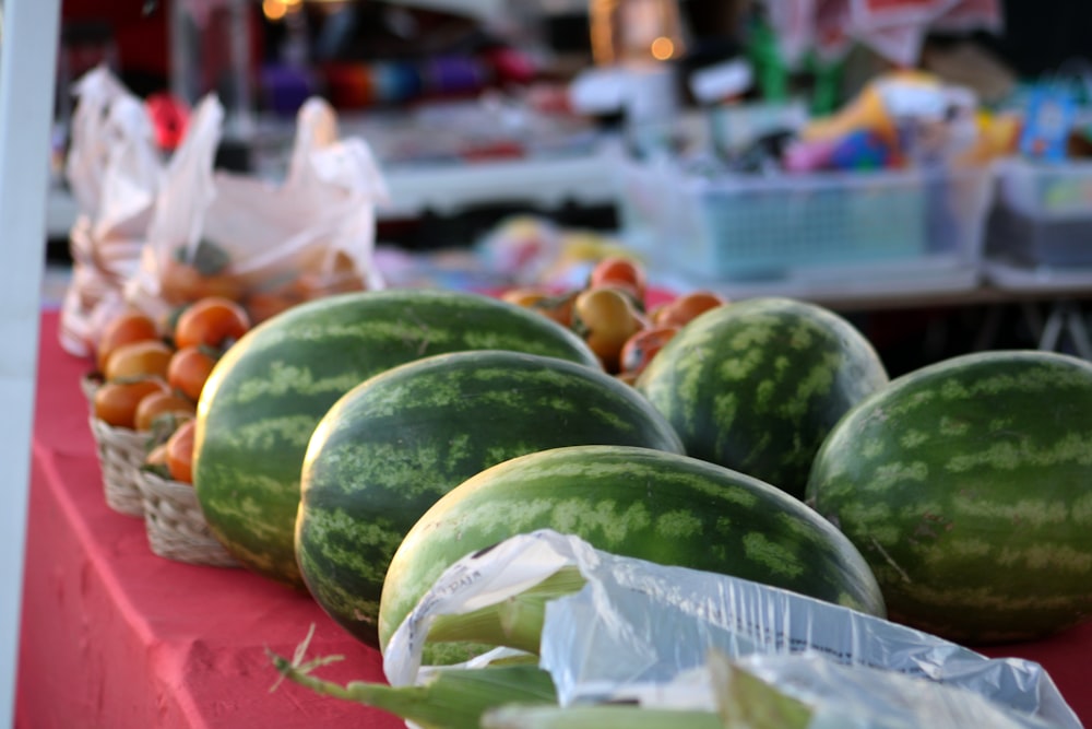 a bunch of watermelons sitting on a table