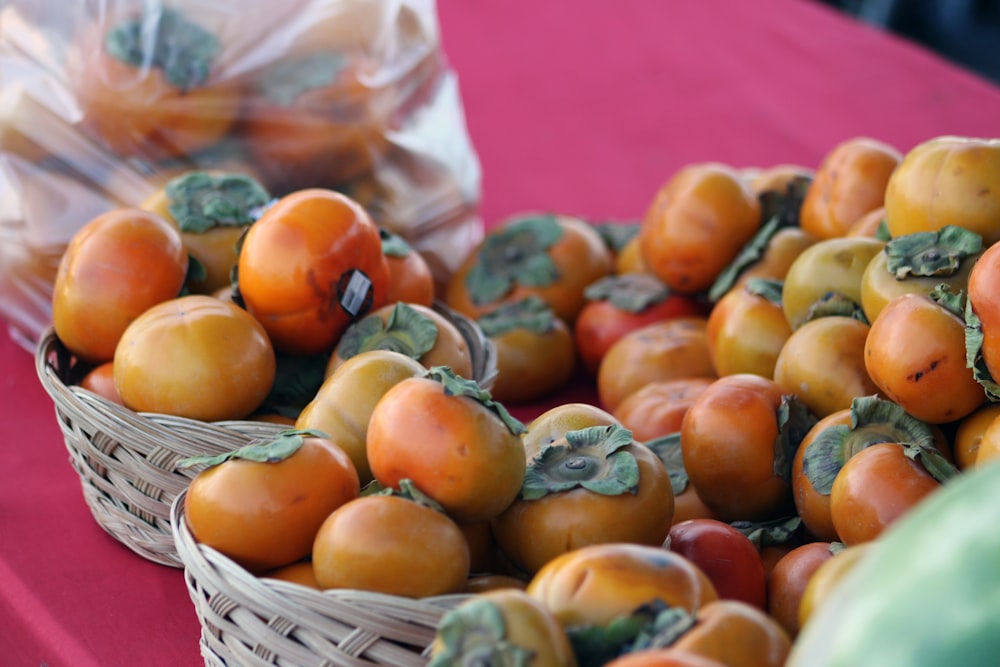 a pile of tomatoes sitting on top of a table