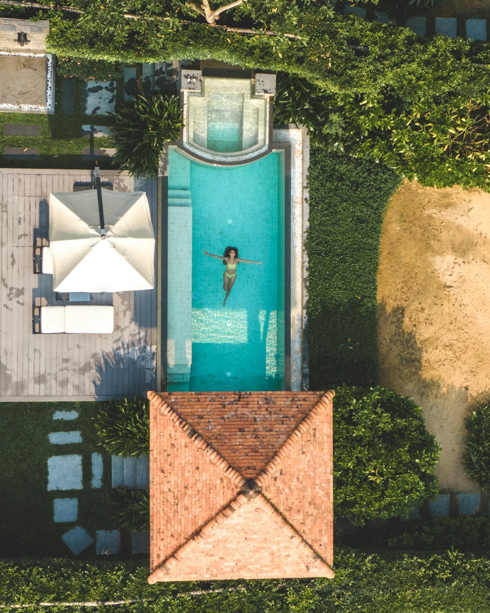 an aerial view of a swimming pool and a patio