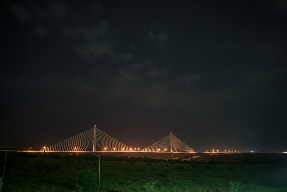 a night view of a bridge with lights on