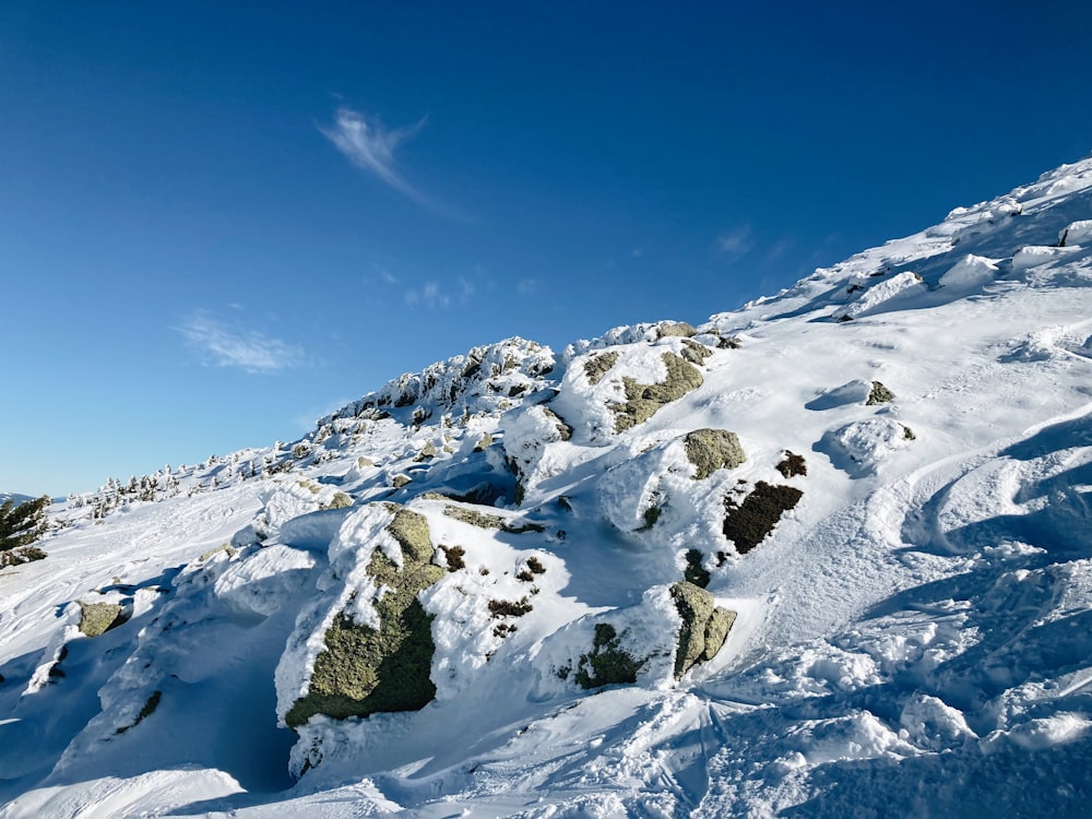 a man riding skis down the side of a snow covered slope