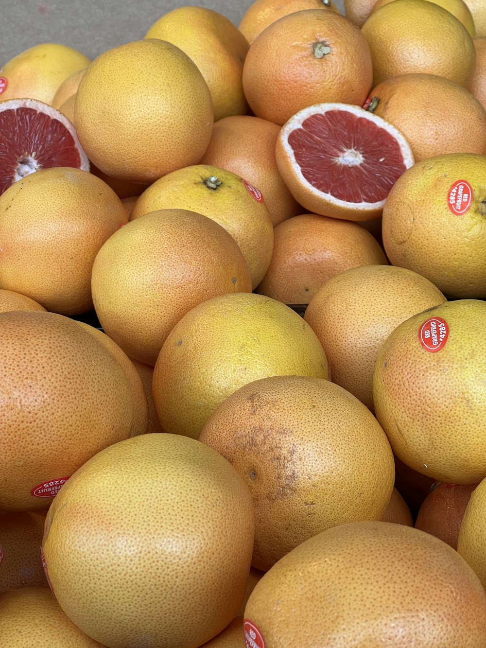 a pile of grapefruits sitting on top of each other