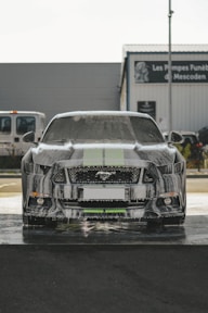 a car covered in snow sitting in a parking lot
