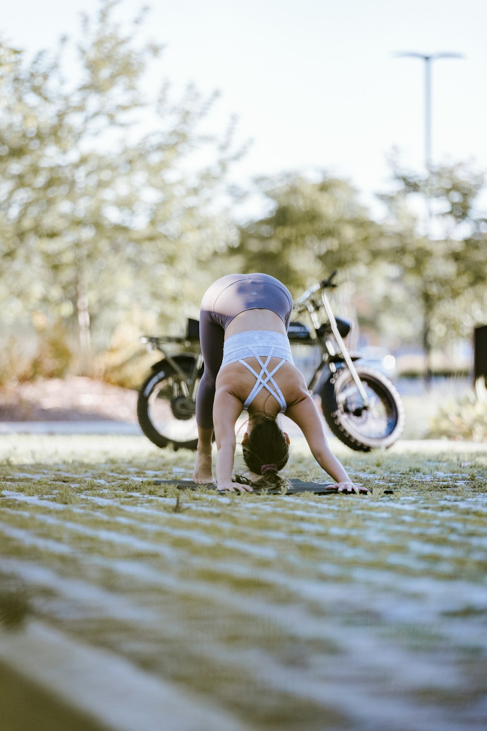 a woman is doing a handstand on the ground