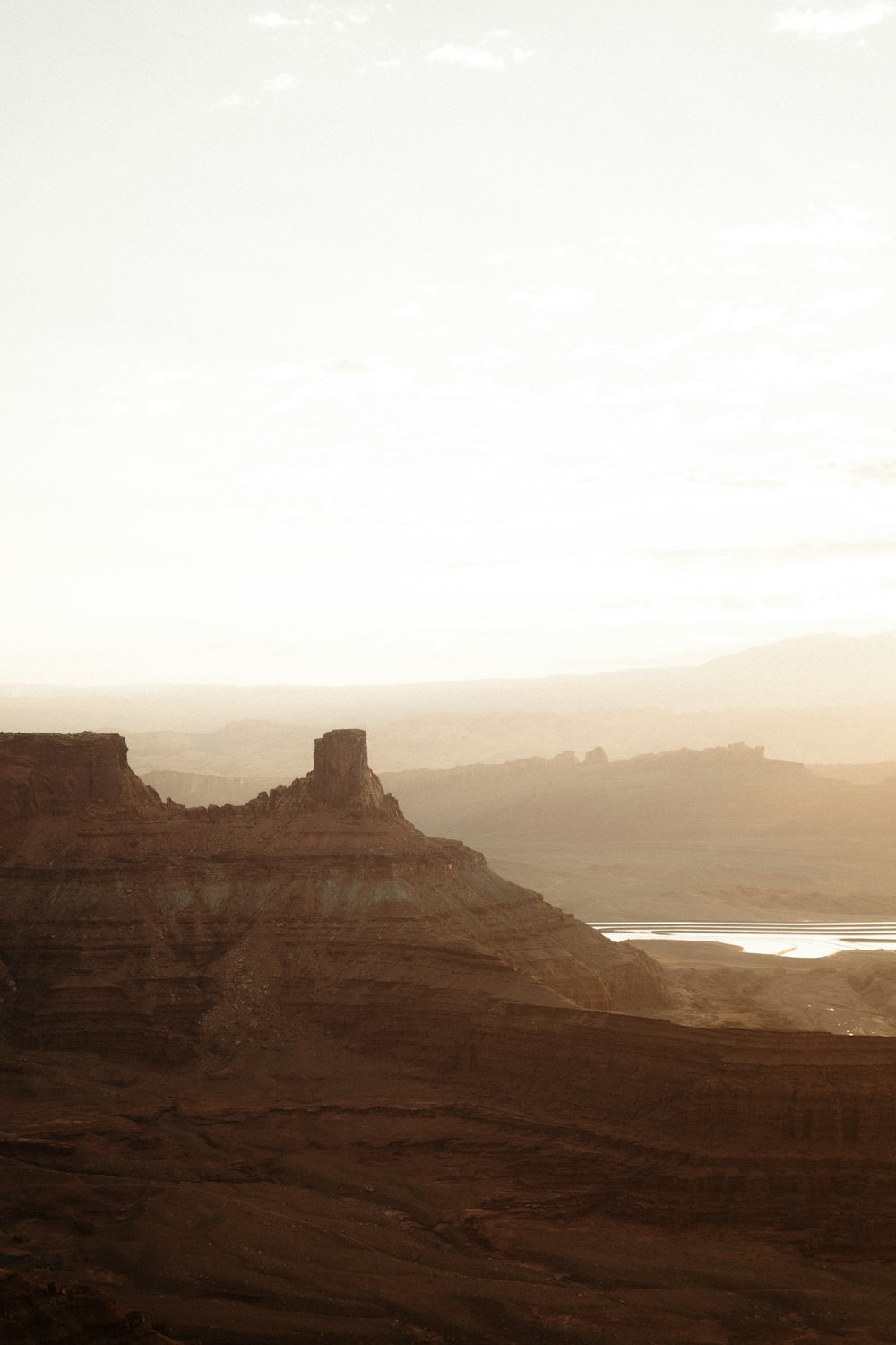 a view of a mountain with a body of water in the distance