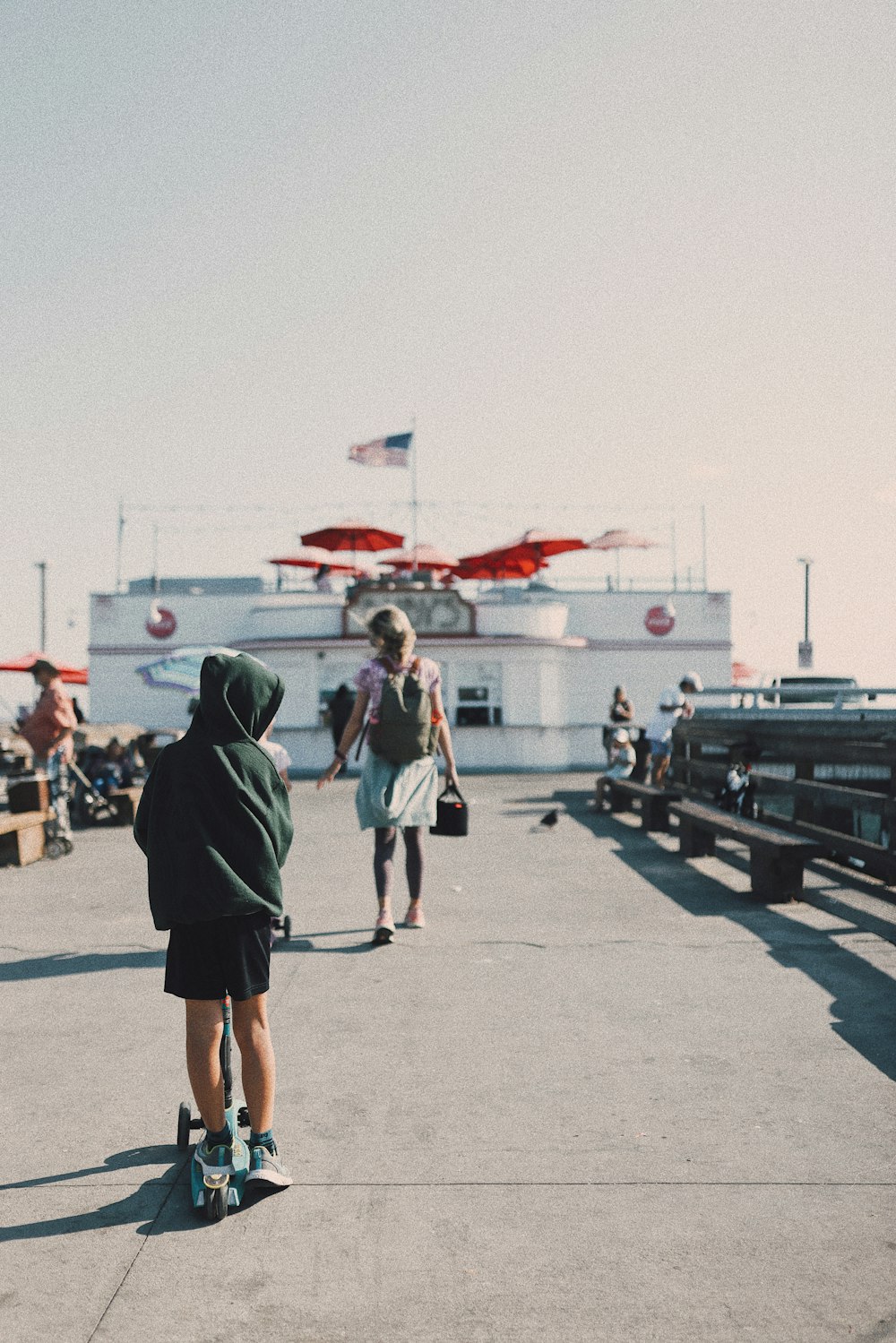 a person standing on a skateboard on a pier