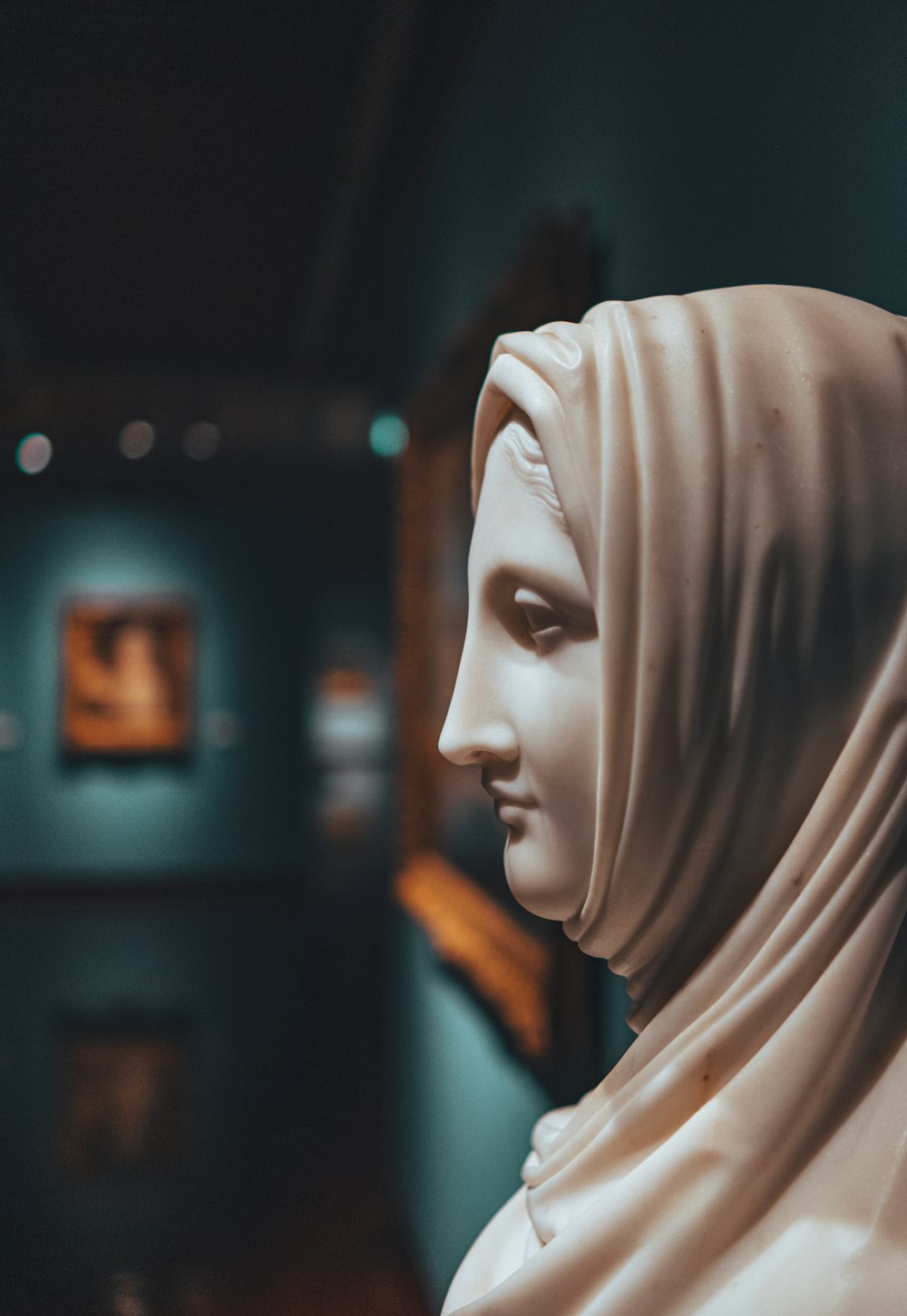 a close up of a statue of a person wearing a headscarf