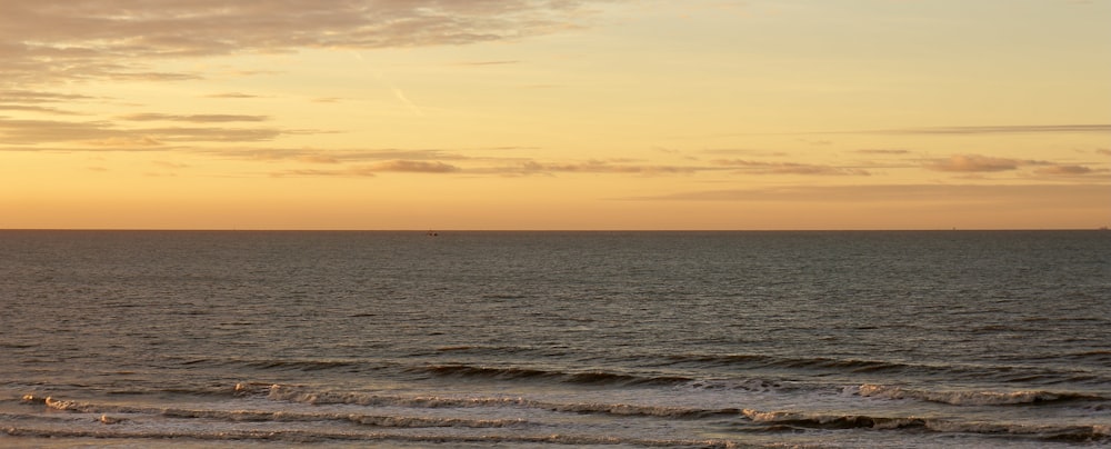 a boat is out on the water at sunset