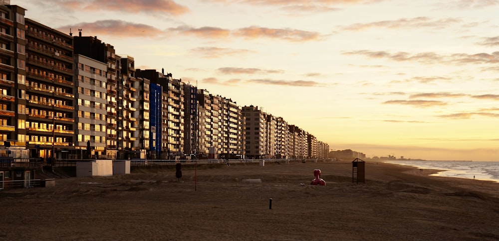 a row of apartment buildings next to the ocean