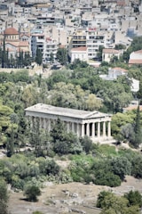 A group of city leaders from Greece and Cyprus collaborating outdoors with a backdrop of urban buildings and greenery.