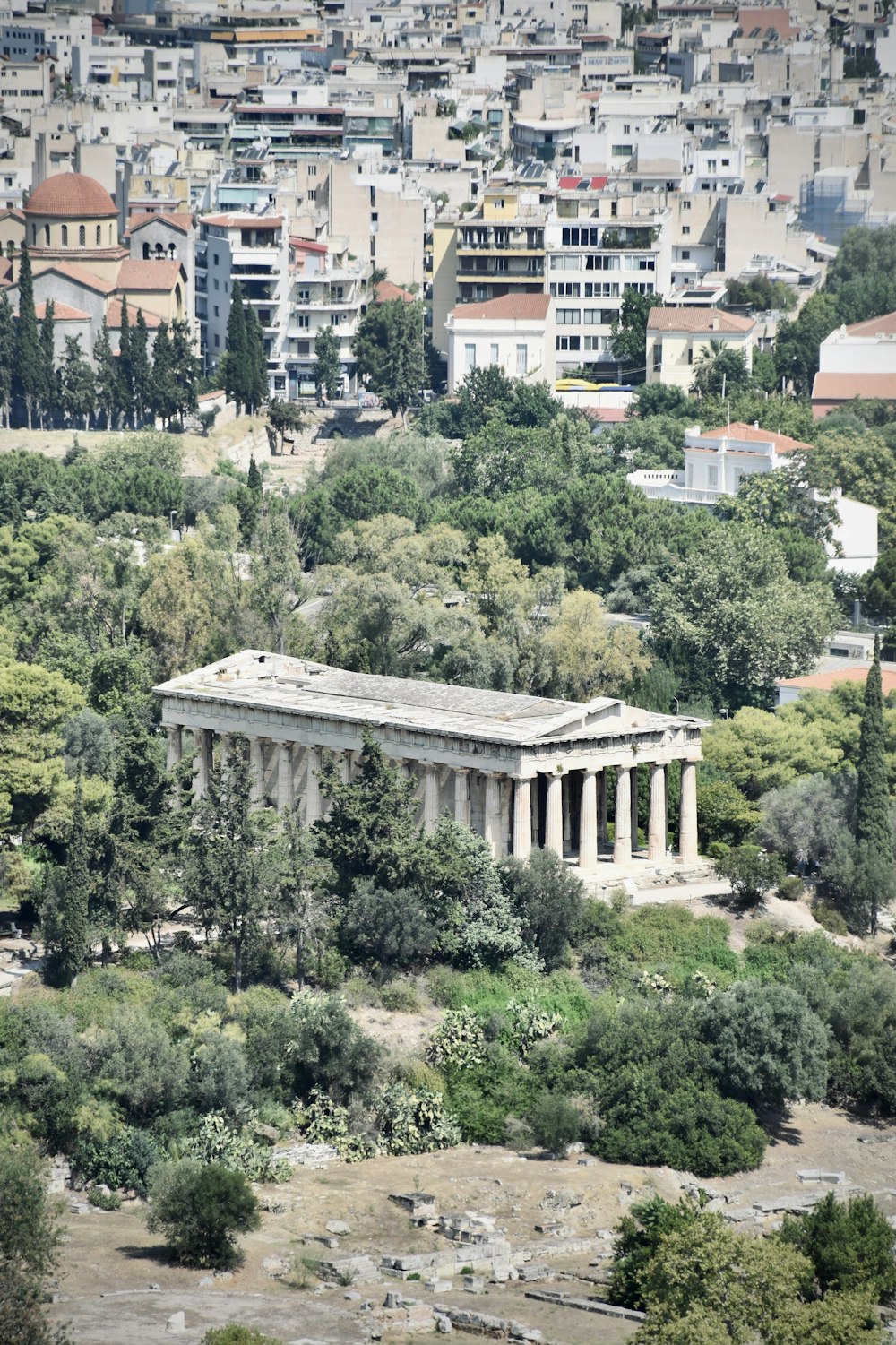 an aerial view of a large building surrounded by trees