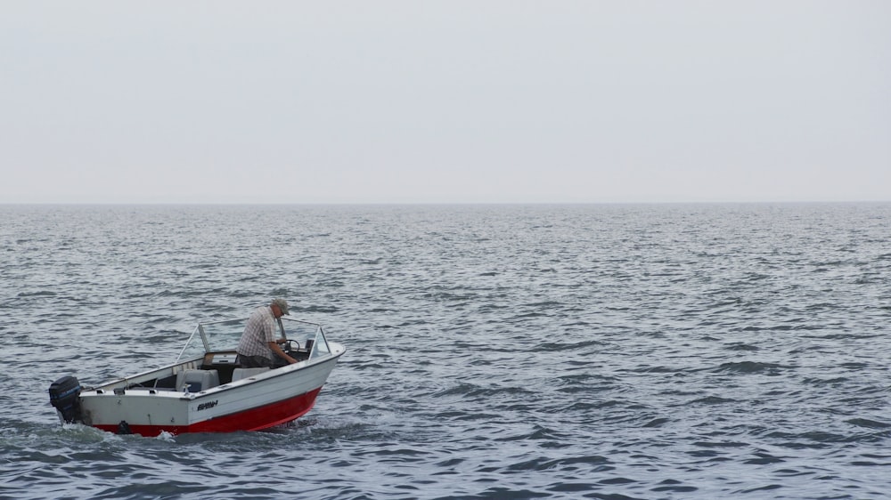a man on a boat in the middle of the ocean