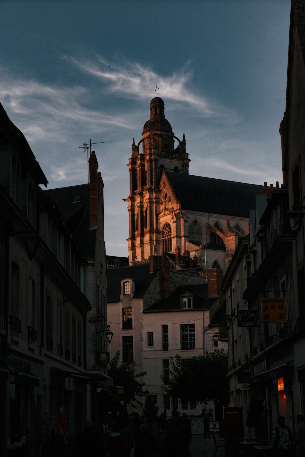 a large cathedral towering over a city filled with tall buildings