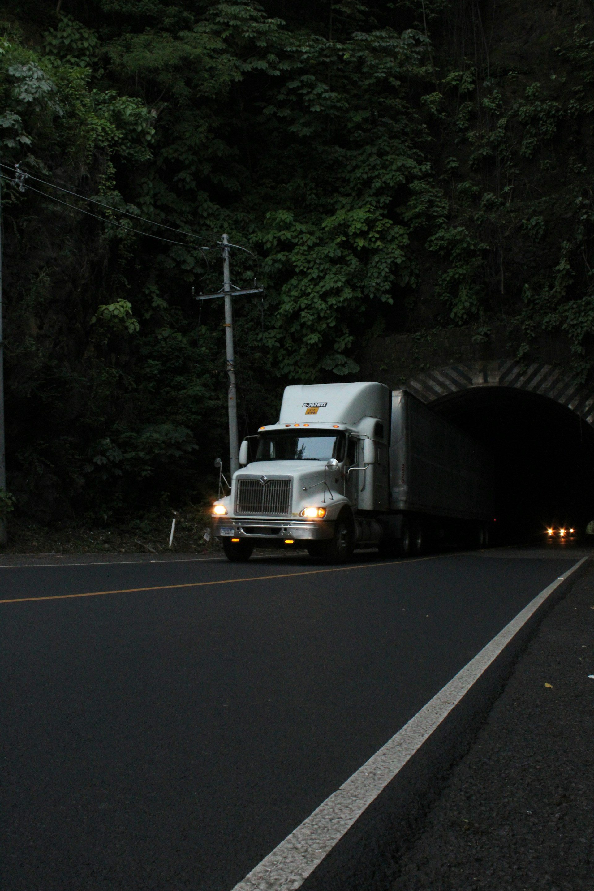 a truck driving into a tunnel at night