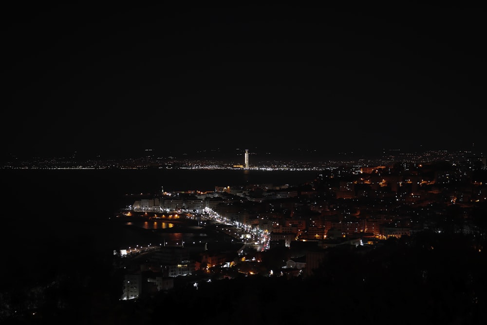 a view of a city at night from a hill