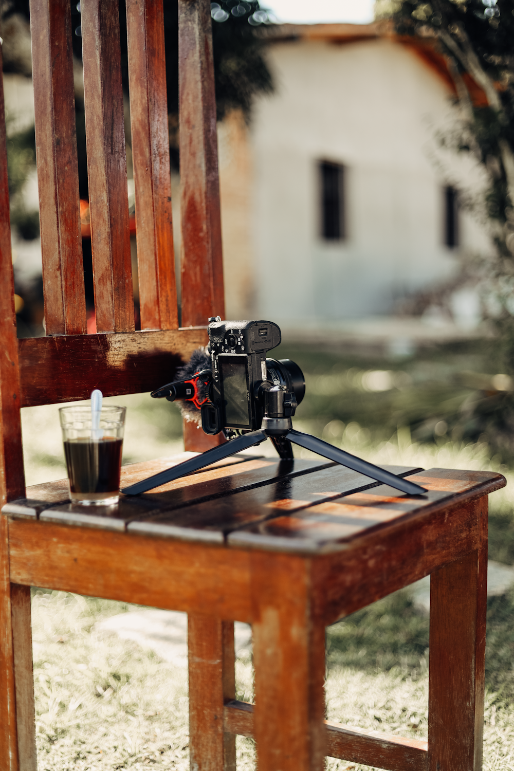 a camera sitting on top of a wooden chair