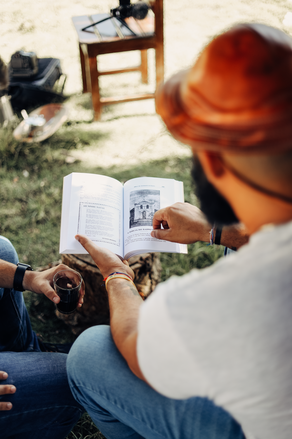 a man sitting on the ground reading a book