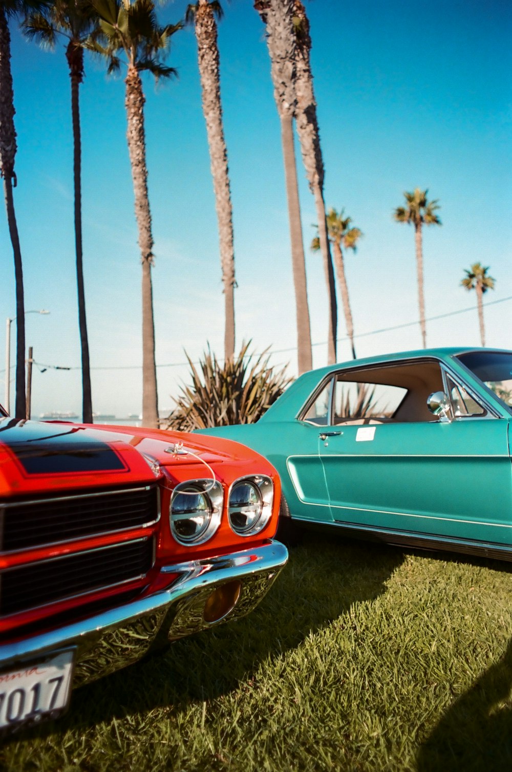 a couple of cars parked next to each other on a field