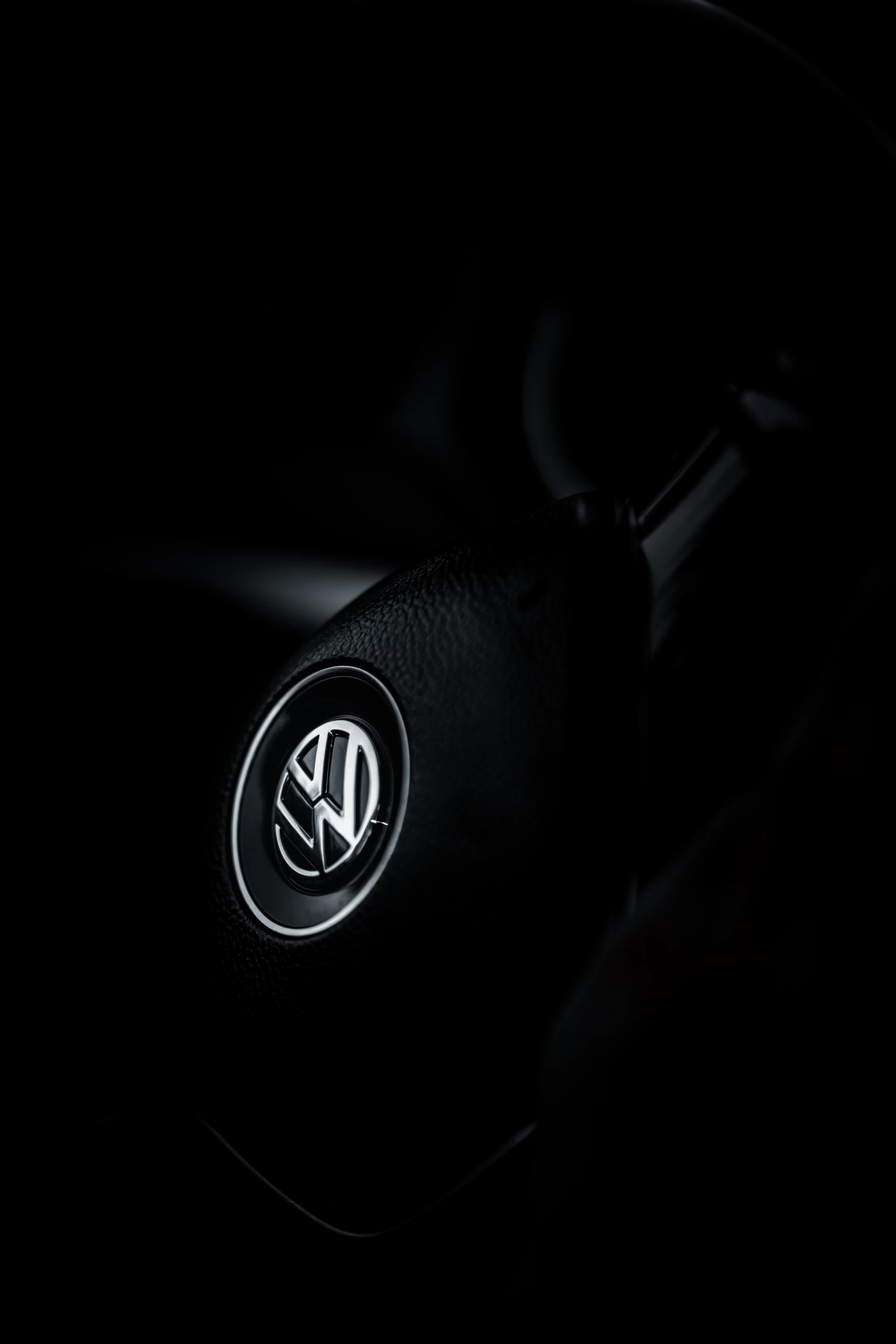 the steering wheel of a car in the dark