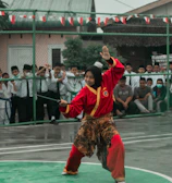 Balamuraleekrishnan demonstrating a karate stance to attentive students.